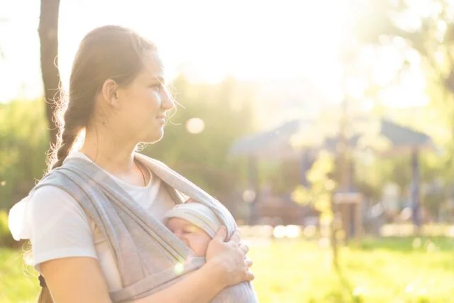 Mother walking in the park with her baby