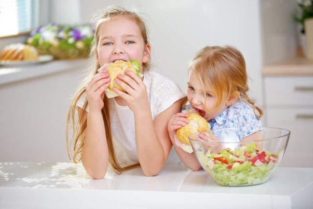 Two kids eating a healthy snack